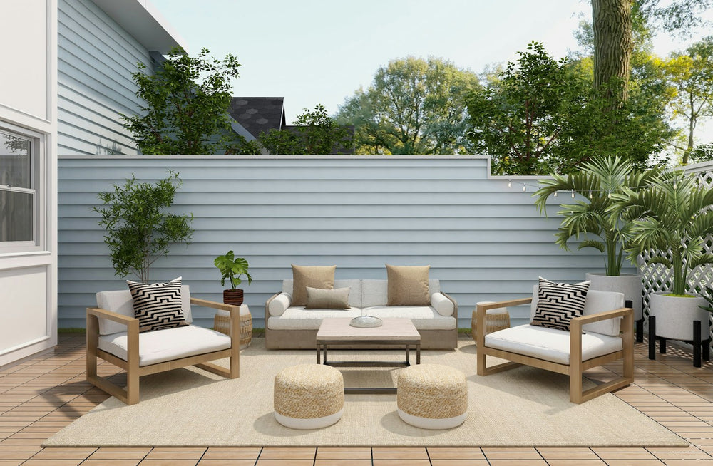 Outdoor living patio with lounge chairs, sofa and potted plants